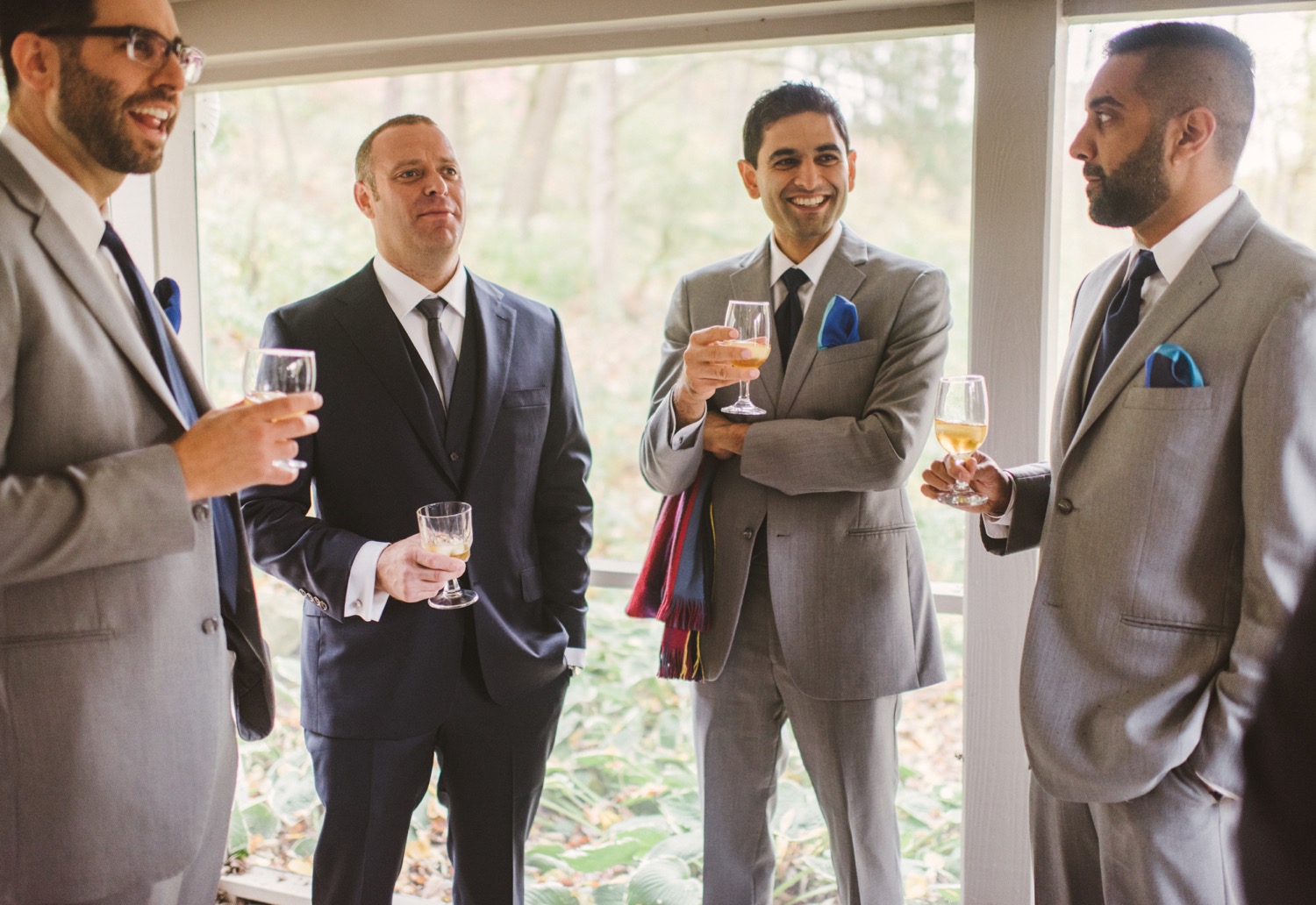 a groom and his groomsmen enjoy a glass of wine before his brookmill farms wedding