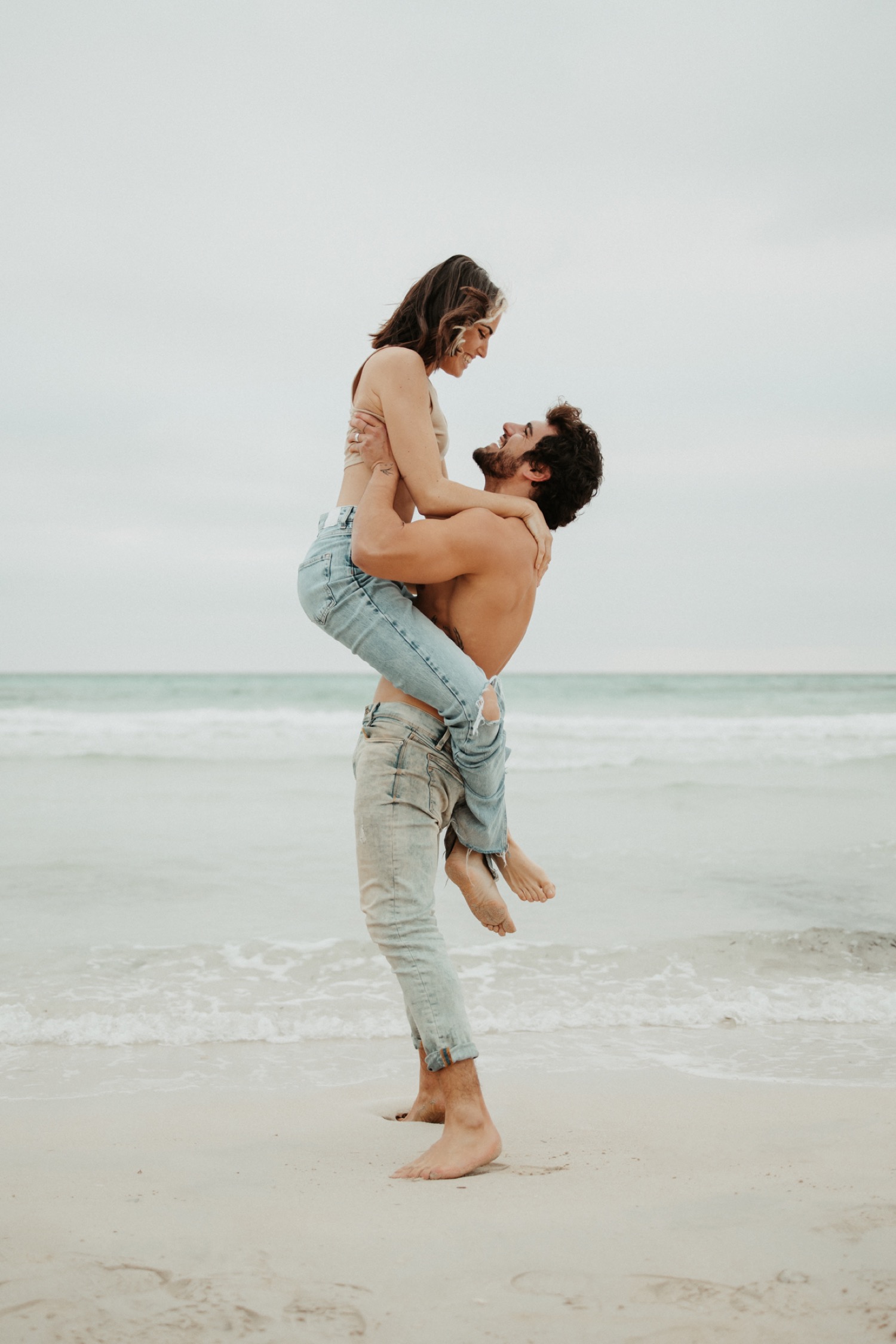 Happy Young Couple Posing In The Beach Stock Photo, Picture and Royalty  Free Image. Image 74542268.