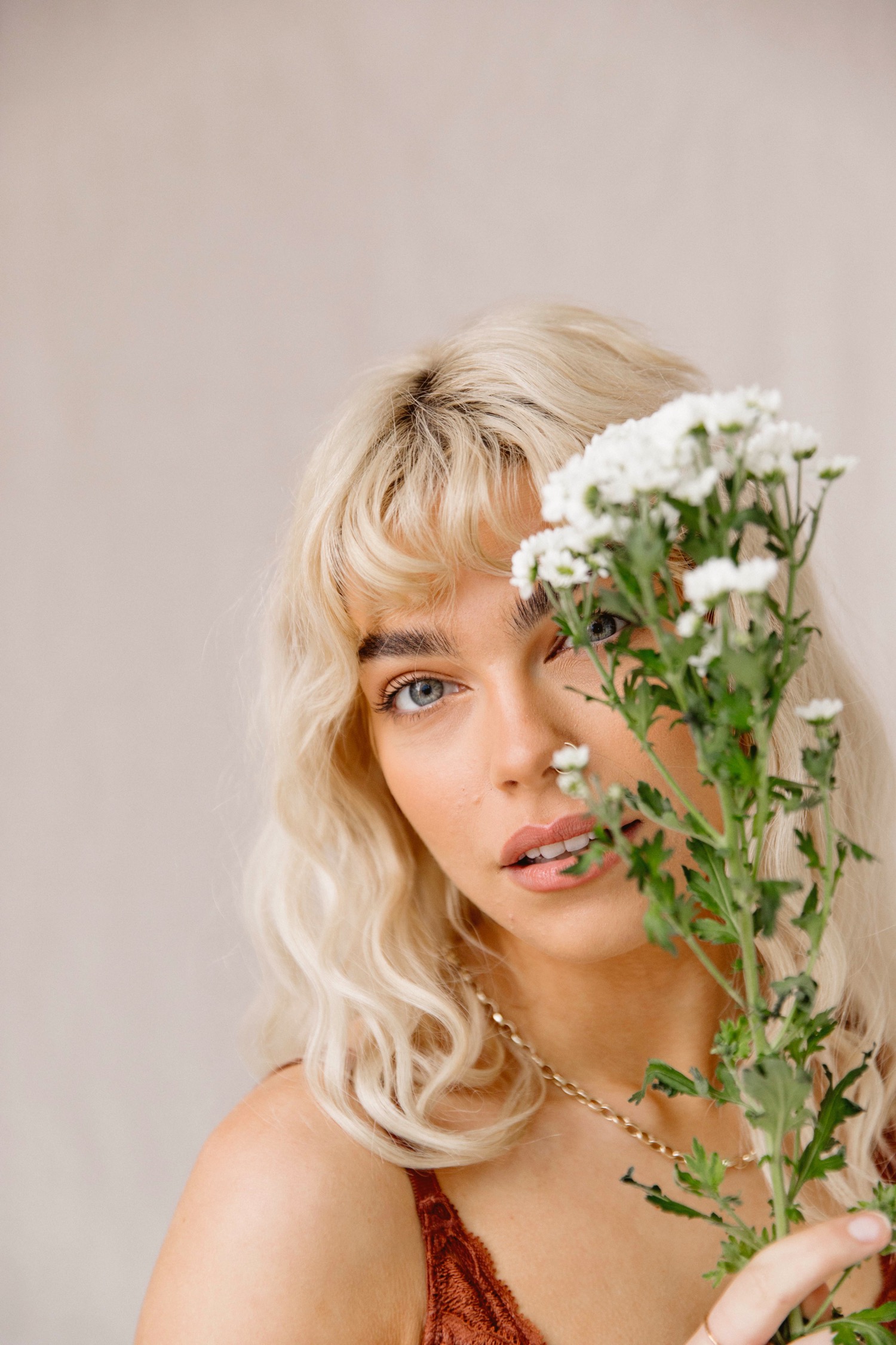 Using flowers as props in photoshoot with a model