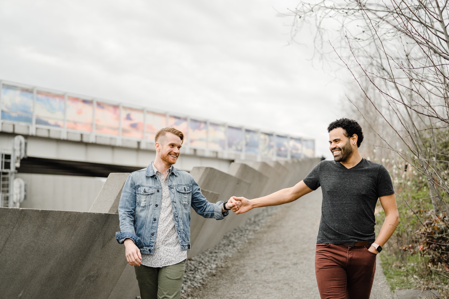 Couple holds hands and walks down a path during couples session