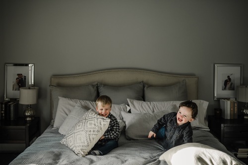 Little boys on the bed with pillows