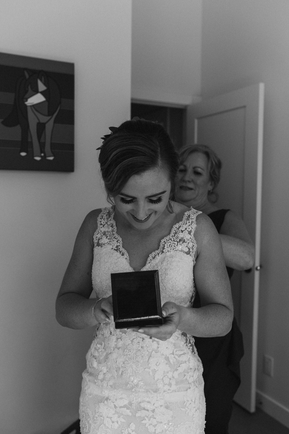 Mother helping the bride get ready in their mountain airbnb in Canmore Alberta