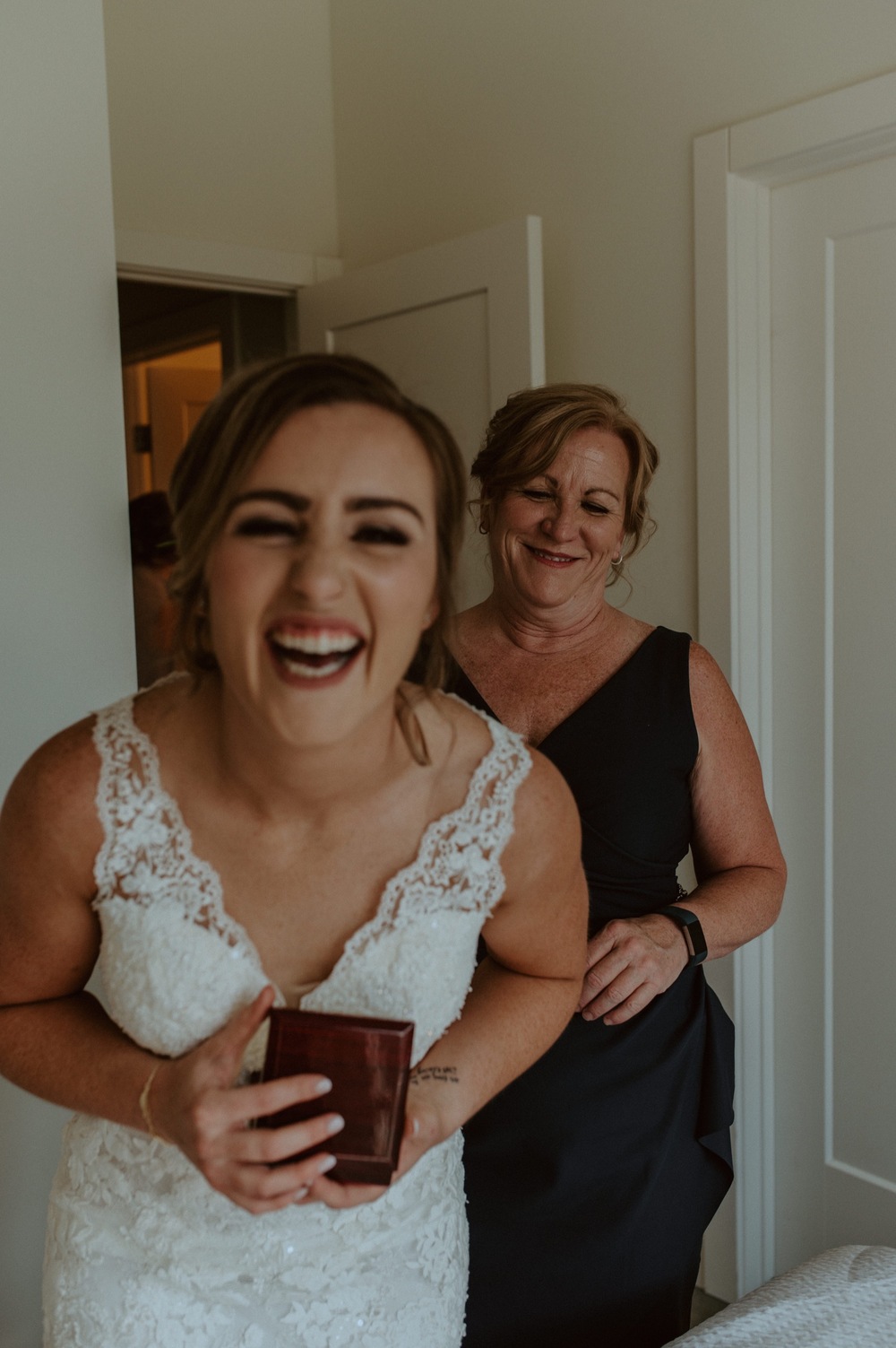 Mother helping the bride get ready in their mountain airbnb in Canmore Alberta