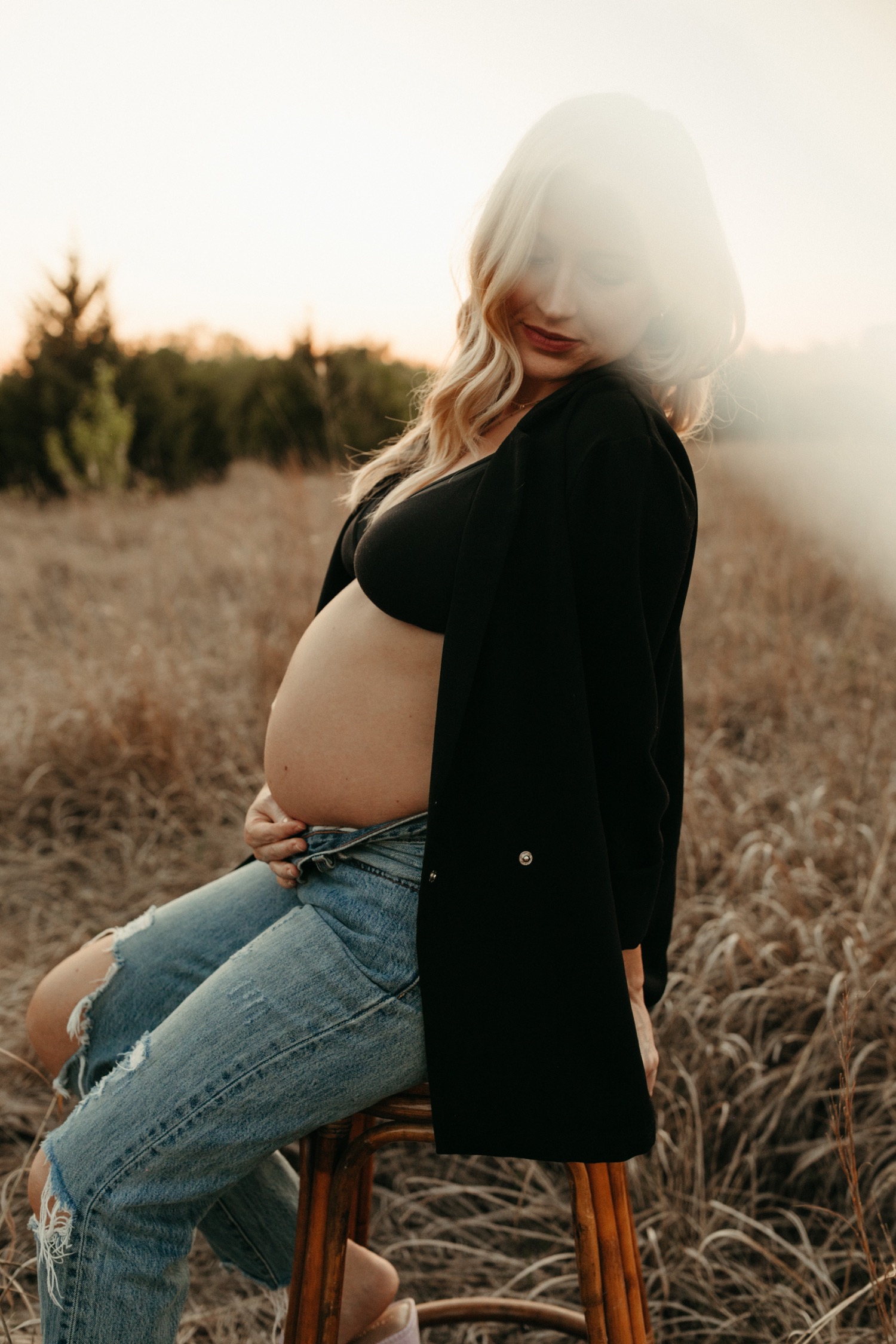 Pregnancy, a couple in light jeans and white T-shirts are sitting on the  floor and the man is holding a pregnant belly Stock Photo by ©Aksinyaeskova  251147664