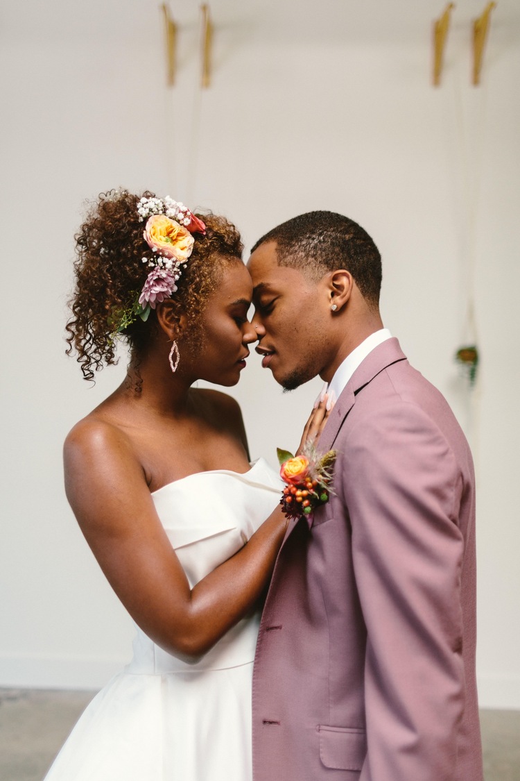 https://content1.getnarrativeapp.com/static/5e88c0ac-537c-493d-9811-ea4092b41372/black-bride-wedding-flowers-flowercrown-white-dress-vintage-laughing-smiling-Model-choyce-brown-couple-bride-and-groom-holding-hands-kissing-cute-Married-rug-bridal-wodern-dress-curly-hair-beautiful-california-editorial.jpg?w=750