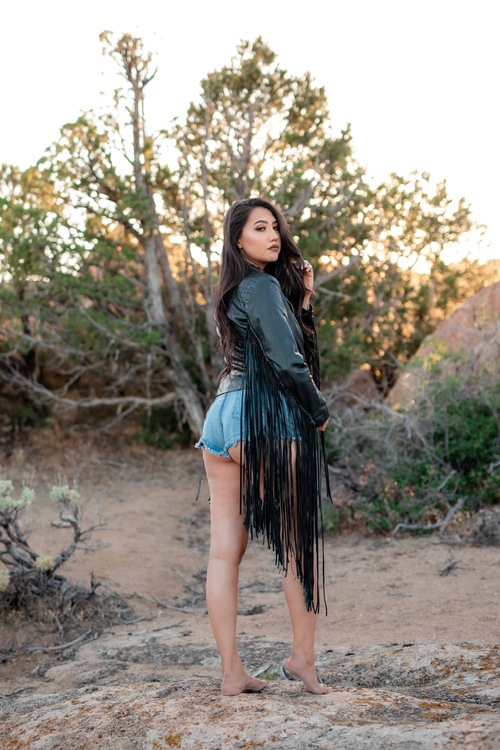 Beautiful Woman Wearing Denim Shorts And Top Outdoors In Desert