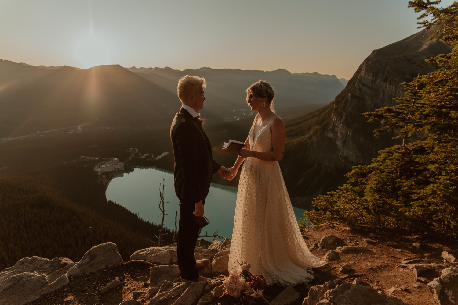 bride reading vows for staged hiking inspired elopement at sunrise above Lake Louise in Alberta