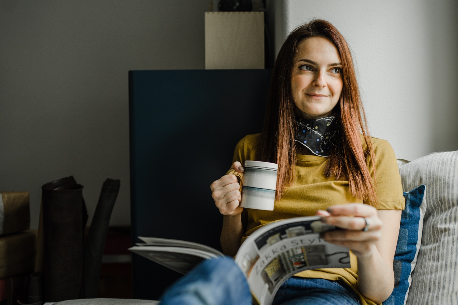 Woman holding mug and reading magazine for studio portraits