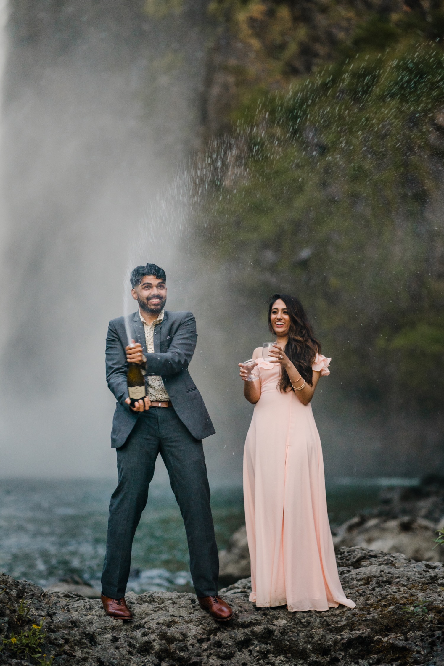 Couple pops champagne after proposal