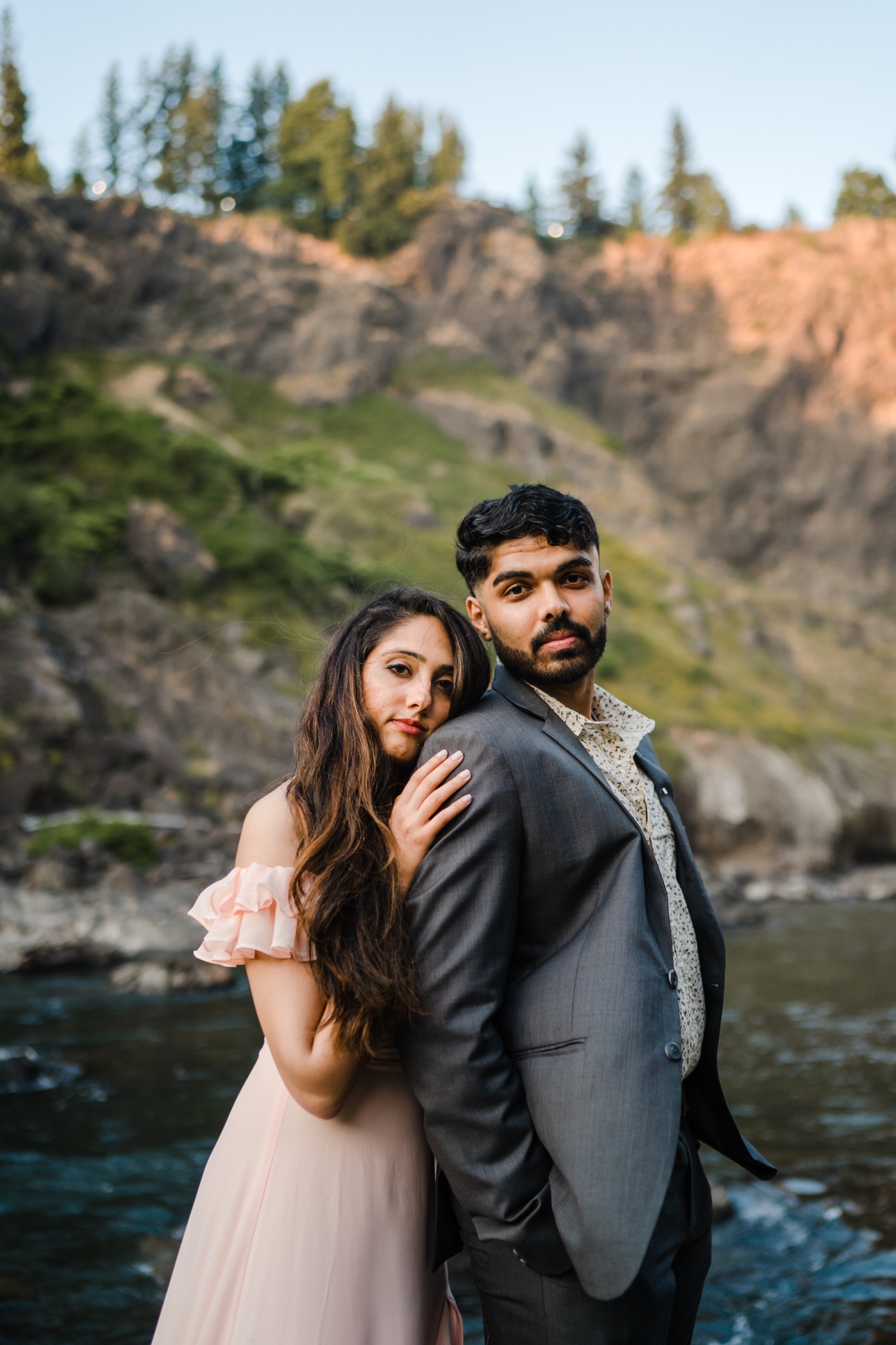 Couple beside a river looking into the camera