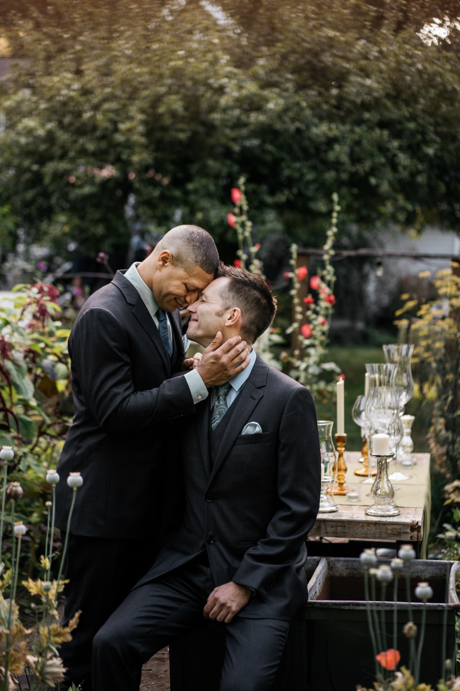 Two grooms taking couple portraits in the garden with good wedding lighting