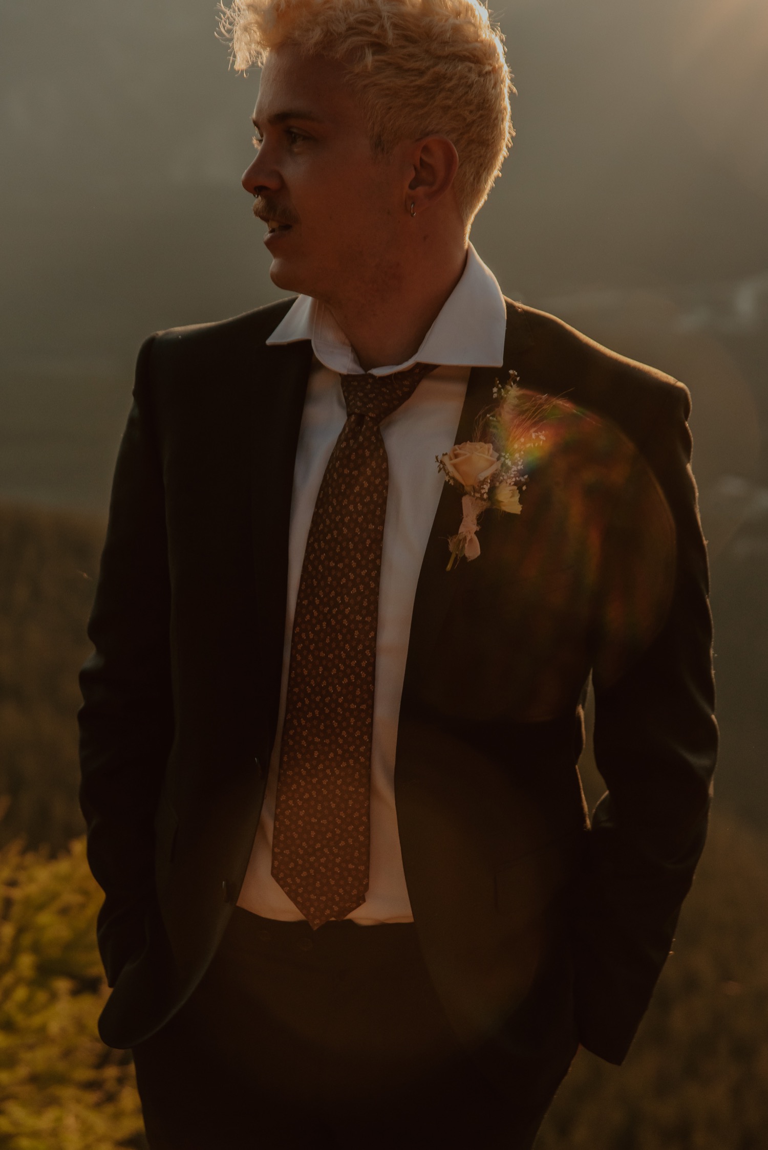 groom portrait shot standing on top of a mountain in Lake Louise Alberta for a sunrise hiking mountain elopement