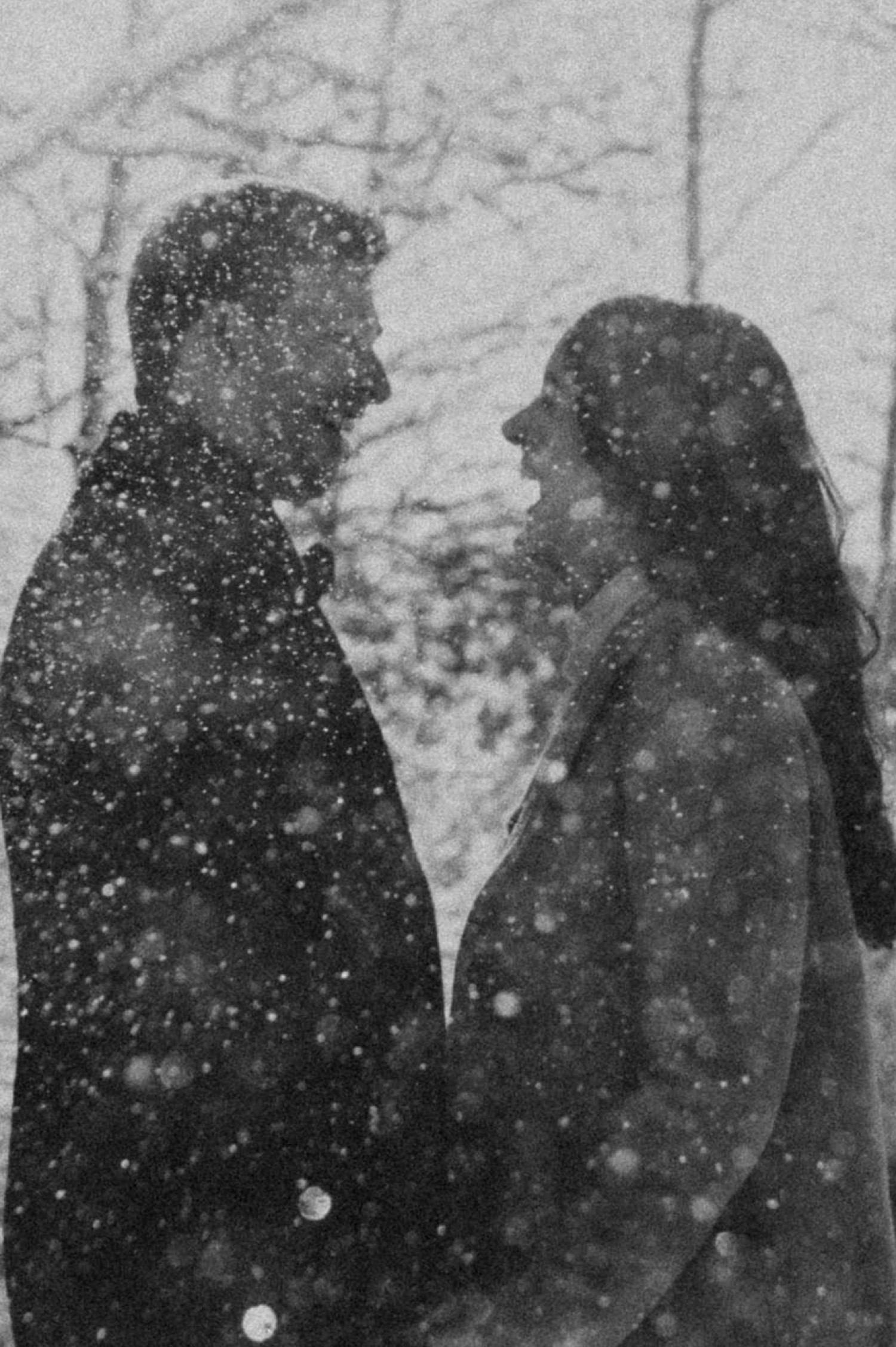 black and white shot of couple in the snow during a winter engagement session in the rocky mountains of alberta