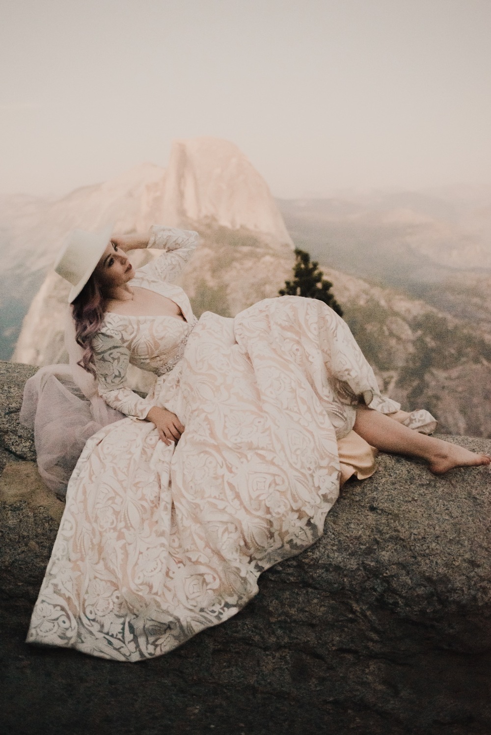https://content1.getnarrativeapp.com/static/e2fe831f-cd9a-4176-8fb9-419e3f3460f1/bride-with-purple-hair-in-hat-and-pink-veil-eloping-at-Yosemite-National-Park.jpg?w=1000