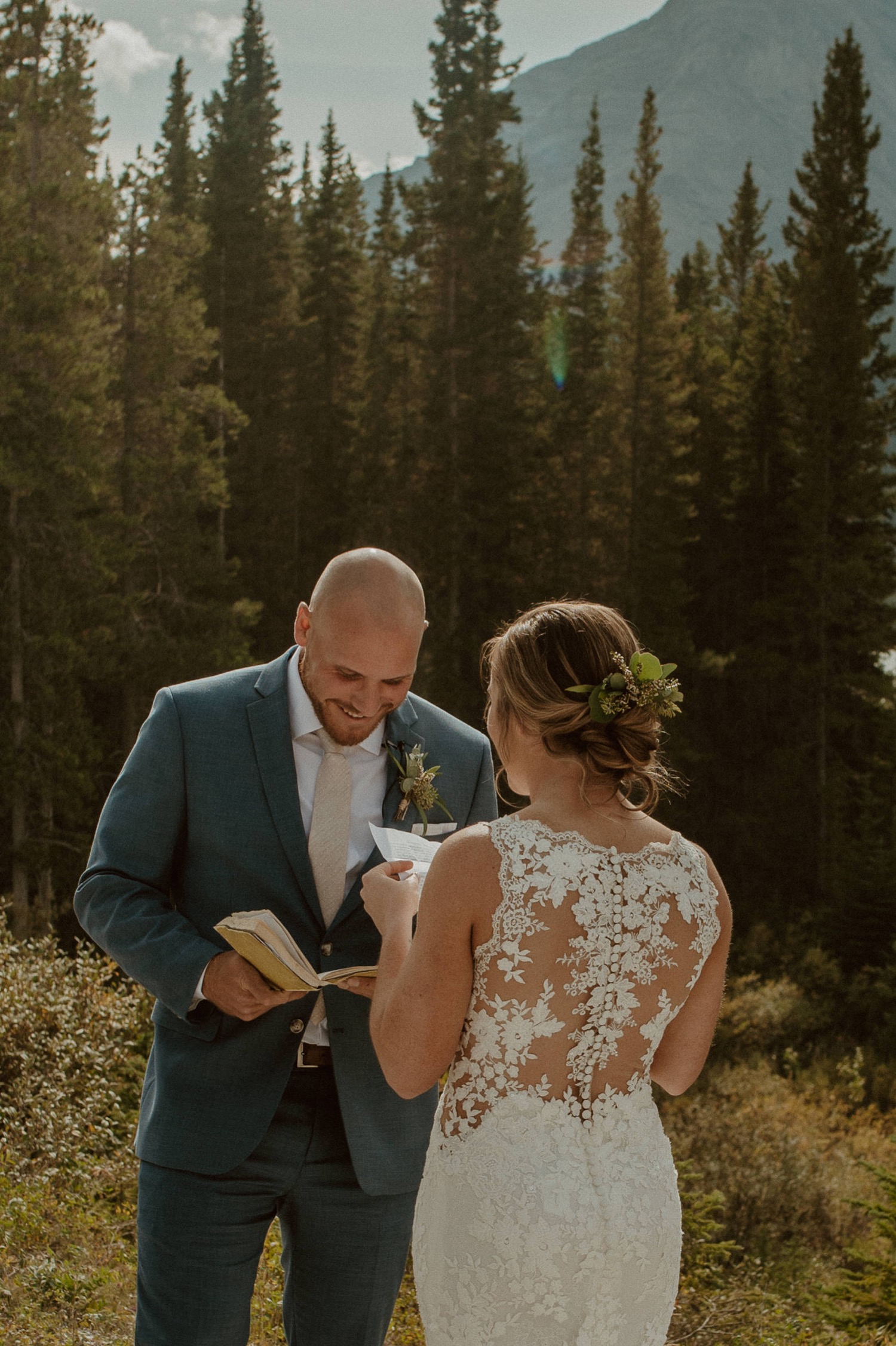 The bride and groom read private letters they wrote to each other before their elopement ceremony with family and friends in Kananaskis Alberta