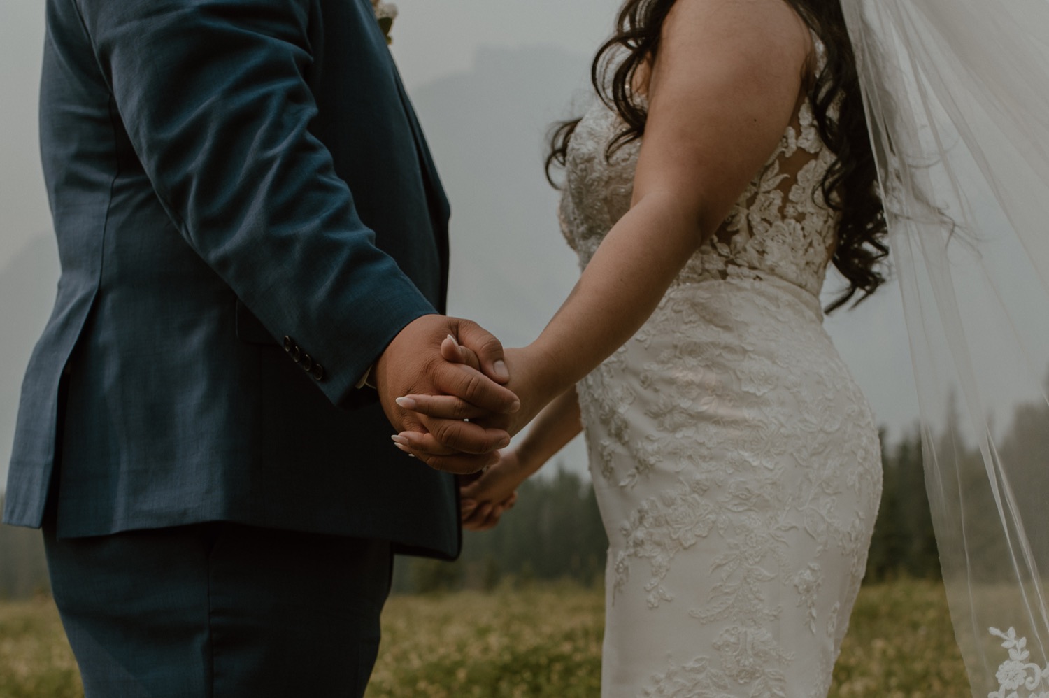 close up shot of bride and groom hands for a mountain elopement during wildfire season in Banff Alberta