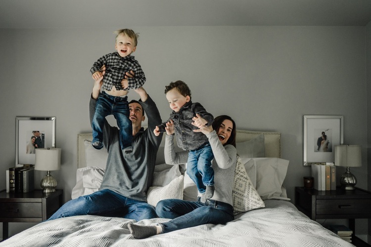 Family playing in bedroom during in-home family session